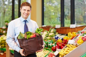9600226-businessman-buying-bag-of-vegetables-in-organic-food-store